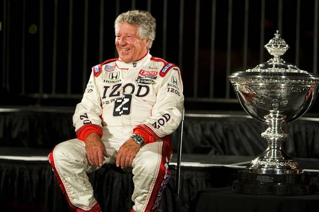 Racing legend Mario Andretti sits by the championship trophy before driver introductions in front of the Bellagio Thursday, Oct. 13, 2011. The IZOD IndyCar World Championship race will be held at the Las Vegas Motor Speedway Sunday.