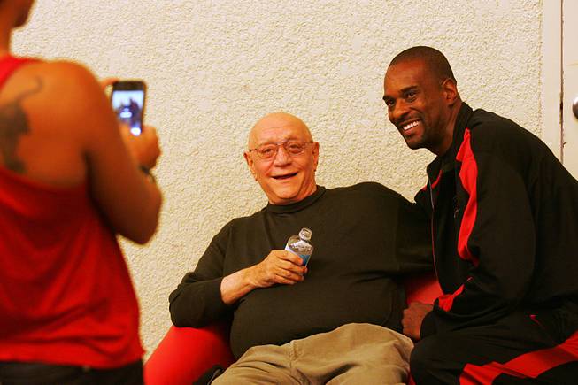 Former UNLV basketball coach Jerry Tarkanian has his photo taken with former player and current coach Stacy Augmon during the Rebel Fan Fest Friday, October 14, 2011 at the Fremont Street Experience.