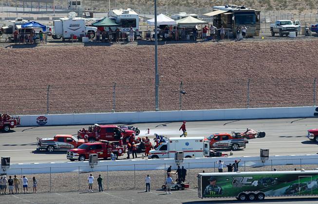 Medical and safety crews respond after a multi-car wreck during the IZOD IndyCar World Championship race at the Las Vegas Motor Speedway Sunday, October 16, 2011. IndyCar driver Dan Wheldon was killed in the crash.
