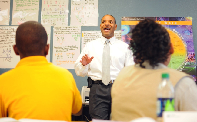 Junior Achievement volunteer Brian Pauling of NV Energy teaches financial literacy to students at Imagine 100 Academy of Excellence in North Las Vegas on Friday, Oct. 21, 2011.
