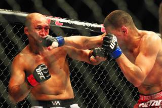 Nick Diaz hits B.J. Penn with a right during their bout at UFC 137 on Saturday, Oct. 29, 2011, at Mandalay Bay Events Center. Diaz won by unanimous decision, and Penn announced his retirement after the fight.
