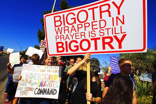 Approximately 150 counter protesters gather across from three Westboro Baptist ...