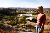 Farm owner Laura Bledsoe stands with Quail Hollow Farm in the background in Overton on Wednesday, Nov. 9, 2011.