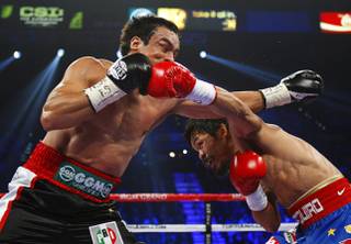 Juan Manuel Marquez, left, of Mexico battles it out with Manny Pacquiao of the Philippines during their WBO welterweight fight at the MGM Grand Garden Arena Saturday Nov. 12, 2011.