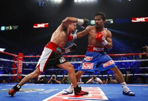 Juan Manuel Marquez, left, of Mexico exchanges punches with Manny Pacquiao of the Philippines during their WBO welterweight fight at the MGM Grand Garden Arena Saturday Nov. 12, 2011.