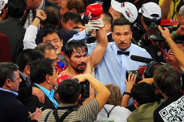 Manny Pacquiao celebrates his majority decision against Juan Manuel Marquez at the MGM Grand Garden Arena Saturday, Nov. 12, 2011.