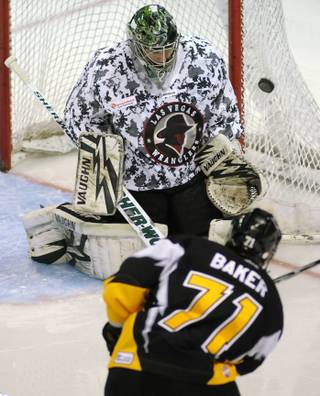 Wranglers goaltender David Brown deflects a second period shot made by Stockton winger Kevin Baker on Saturday night.