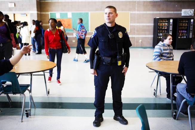 Clark County School District Police officer John Maier watches students during lunch inside the cafeteria at Mojave High School in North Las Vegas on Thursday, Nov. 17, 2011.