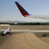 An American Airlines jet waits to taxi as a Southwest Airlines jet takes off from McCarran International Airport in this 2009 file photo.