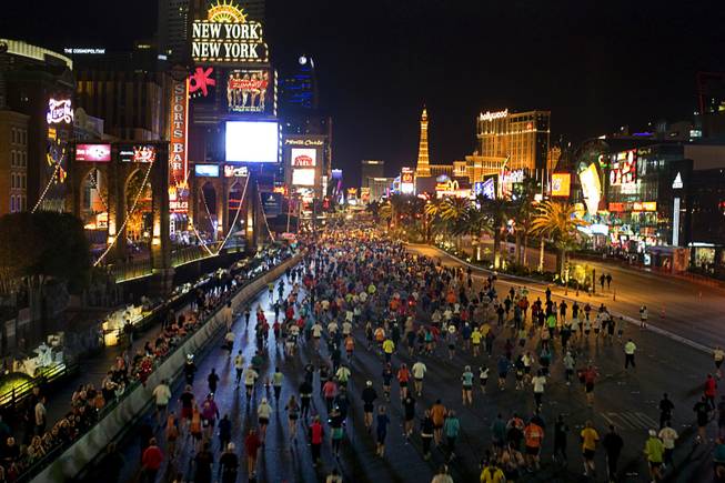Runners head northbound on the Las Vegas Strip during the ...