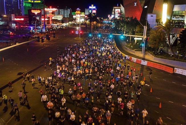 Runners head northbound on the Las Vegas Strip during the ...