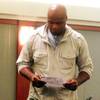 Former NBA basketball player Antoine Walker looks over paperwork Tuesday, Dec. 6, 2011 after he was sentenced to five years of probation and ordered to pay more than $750,000 in gambling debts.