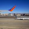 A United Airlines passenger jet is shown on the ground as a Southwest jet takes off at McCarran International Airport on Dec. 9, 2011.