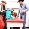 J.W. Harris, center, a bullrider with a broken foot, comes into the Justin Sportsmedicine Team room after landing on his already broken foot while riding at the National Finals Rodeo at the Thomas & Mack Center in Las Vegas Friday, December 9, 2011.