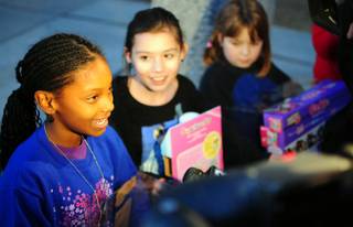 Kynedi Harris, 10, talks with the media as Jolie Leach, 11, looks on after the private Justin Bieber concert at Whitney Elementary School on Friday, Dec. 16, 2011. Bieber donated $100,000 to the east Las Vegas school, which serves many homeless and low-income students.