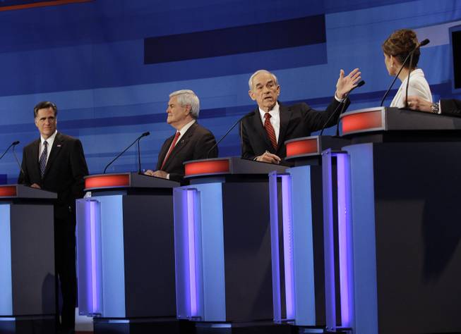 Republican presidential candidates from left, former Massachusetts Gov. Mitt Romney, former House Speaker Newt Gingrich, Rep. Ron Paul, R-Texas, and Rep. Michele Bachmann, R-Minn., participate in a Republican presidential debate in Sioux City, Iowa, Thursday, Dec. 15, 2011. 