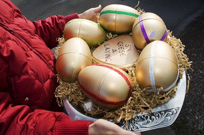Volunteer Niki English., 13, brings six eggs to the Ramos family in Henderson as part of the 12 Days of Christmas Sunday, December 18, 2011. Inside each egg is a message detailing an adventure that family members will receive during an overnight vacation at the Loews Lake Las Vegas Resort. Twelve Days is a volunteer-based project aiming to bring the 12 days of Christmas to unsuspecting people in the Las Vegas Valley.