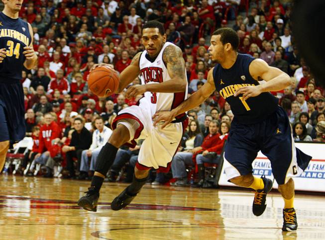UNLV's Anthony Marshall is covered by Cal's Justin Cobbs as he takes the ball down court at the Thomas and Mack Center Friday, December 23, 2011. STEVE MARCUS