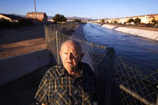 North Las Vegas homeowner Rex Austin stands near near Sloan Channel, which is located close to his home, on Monday, Dec. 26, 2011. Austin is complaining that the North Las Vegas wastewater treatment plant is releasing water into the channel that is causing growth in fungus gnats and chronomid midges around his home. Clark County and the plant are in a legal battle over the issue.