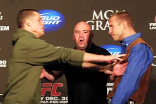 UFC President Dana White separates Nate Diaz, left, and Donald Cerrone after Diaz shoved Cerrone during a news conference Wednesday, Dec. 28, 2011 in advance of UFC 141 on Friday.