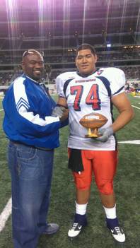 Desert Pines High School football coach Paul Bennett and Jaguars senior offensive tackle Cedrick Poutasi pose for a picture at Cowboys Stadium in Arlington, Texas, after Poutasi was named the top lineman Offense-Defense All-American Bowl. The 6-foot-6, 325 pound Poutasi also verbally committed to Utah during the game.