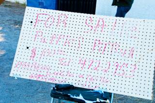 A hand-written sign advertising Pit-bull puppies for sale is displayed outside a home at 2988 E. Reno Ave., Las Vegas, Thursday, Jan. 5, 2011
