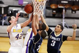 Joe Tuss, from left, of Durango along with teammate Dartangan Rollins grab a rebound from Spring Valley's Justin Profit and Deshaun Nowlin during a game at Durango High School in Las Vegas on Thursday, January 5, 2012.