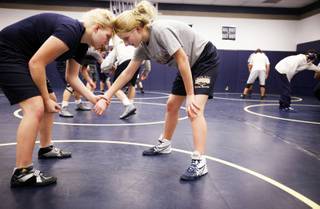 Legally blind Shadow Ridge High School wrestler and sophomore Meghan Clark, left, practices with her sister Emily, a freshman, who is also on the wrestling team, at Shadow Ridge High School in Las Vegas on Thursday, January 5, 2012.