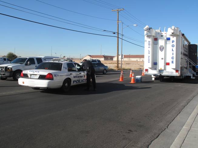 North Las Vegas Police gather in the 2100 block of Lawry Avenue, near the site of an armed standoff Friday, Jan. 6, 2012, between police and two men spotted fleeing from a pawn shop where an armed robbery had been reported.