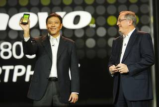 Liu Jun (L), Lenovo senior vice president and president of Mobile Internet and Digital Home, introduces the Lenovo K800 smart phone, based on Intel technology, during a keynote address by Paul Otellini (R), president and CEO of Intel Corporation, at the 2012 International Consumer Electronics Show (CES) in Las Vegas, Nevada, January 10, 2012. The phone will be available in Chine in the second quarter of 2012, he said. CES, the world's largest consumer technology tradeshow, runs through Friday.