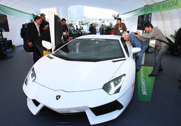 A Lamborghini Aventador LP700-4 with a Nvidia infotainment system attracts attention from showgoers during the 2012 International Consumer Electronics Show (CES) in Las Vegas, Nevada, Jan. 11, 2012. CES, the world's largest consumer technology tradeshow, runs through Friday.