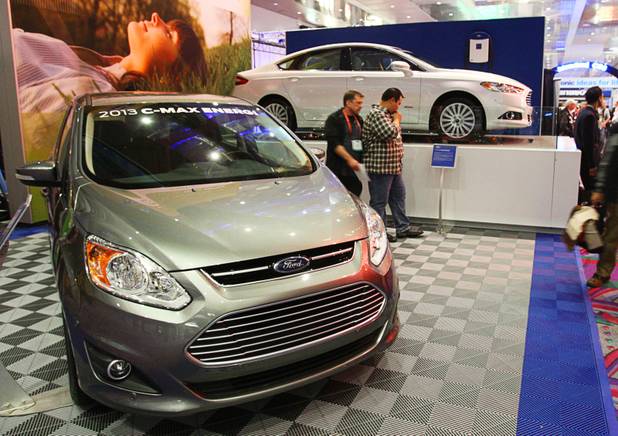 The 2013 Ford C-Max Energi (L) and 2013 Ford Fusion Energi hybrids are displayed in the lobby of the Las Vegas Convention Center during the 2012 International Consumer Electronics Show (CES) in Las Vegas, Nevada, Jan. 11, 2012. The Fusion Energi is expected to hit over 100 miles per gallon equivalent (MPGe), according to company literature. CES, the world's largest consumer technology tradeshow, runs through Friday.