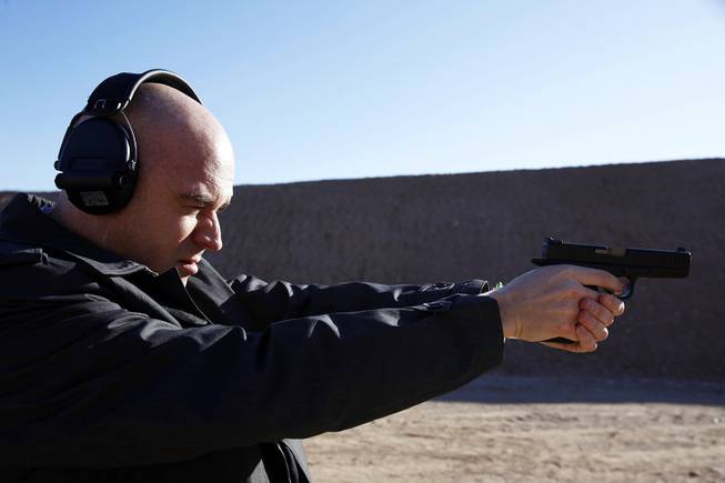 Patrick Coolican shoots a Glock at Desert Hills Shooting Club in Boulder City on Monday, Jan. 16, 2012.