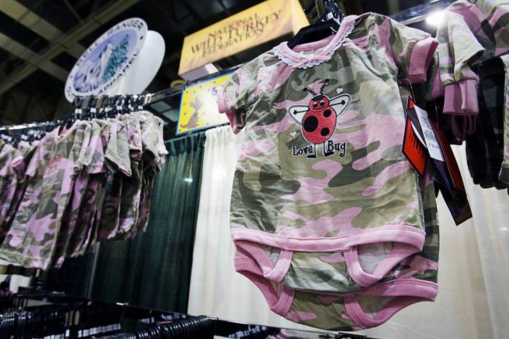 Pink camouflage clothing for toddlers is displayed at the Bell Ranger Outdoor Apparel booth during the first day of the SHOT (Shooting, Hunting, Outdoor Trade Show) at the Sands Expo & Convention Center Tuesday, Jan. 17, 2012. Camouflage clothing for infants and toddlers is a growing segment of the market, said company president Joe Levy.