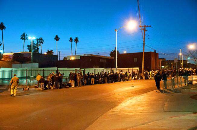 Hundreds of homeless wait in front of Catholic Charities of Southern Nevada hoping to get a place to sleep for the night on Wednesday, Jan. 18, 2012.