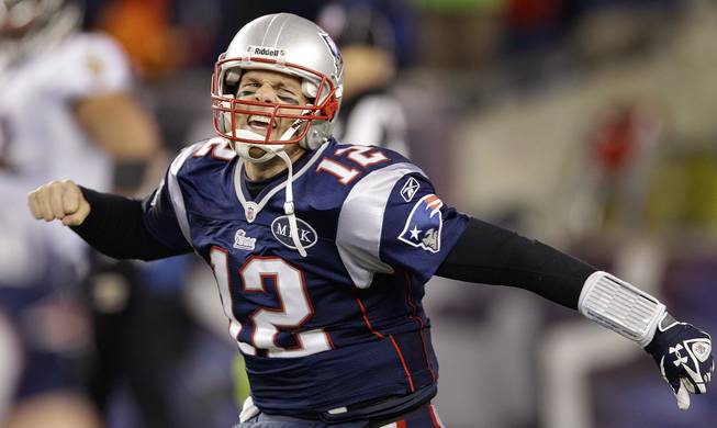 New England Patriots quarterback Tom Brady celebrates after scoring a one-yard touchdown during the second half of the AFC Championship game against the Baltimore Ravens on Sunday, Jan. 22, 2012, in Foxborough, Mass.