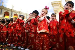 Kindergartners dance and sing during a traditional dragon parade performed by students from The Meadows School to celebrate Chinese New Year at the Forum Shops at Caesars Palace Monday, Jan. 23, 2012.