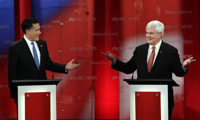 Republican presidential candidates Mitt Romney, left, and Newt Gingrich gesture during a Republican presidential debate Jan. 23, 2012, at the University of South Florida in Tampa, Fla. 