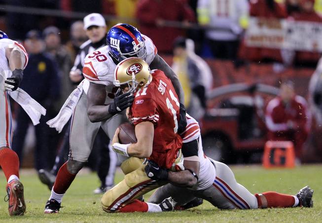 New York Giants defensive linemen Justin Tuck (91) and Jason Pierre-Paul (90) make a sack during an NFC Championship NFL football game against San Francisco 49ers quarterback Alex Smith (11) on Sunday, Jan. 22, 2012, in San Francisco. The Giants won the game, 20-17.