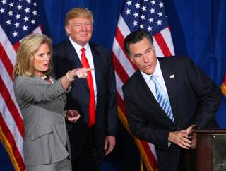 Ann Romney points out someone in the audience to her husband Republican presidential candidate, former Massachusetts Gov. Mitt Romney, after businessman Donald Trump, center, endorsed Romney's presidential bid during a news conference at the Trump International Hotel  in Las Vegas, Nevada February 2, 2012.