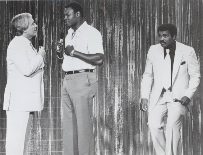 Muhammad Ali sneaks up on Larry Holmes as television host ...