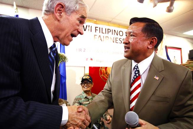 Rep. Ron Paul shakes hands with Ceasar Elpidio, the president and founder of the Filipino-American Veterans of America, after Paul spoke at a rally for Philippine-American veterans at the Leatherneck Club in Las Vegas Friday, Feb. 3, 2012.