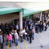 Voters line up to sign in for the Republican presidential caucus at Green Valley High School in Henderson on Saturday, Feb. 4, 2012.