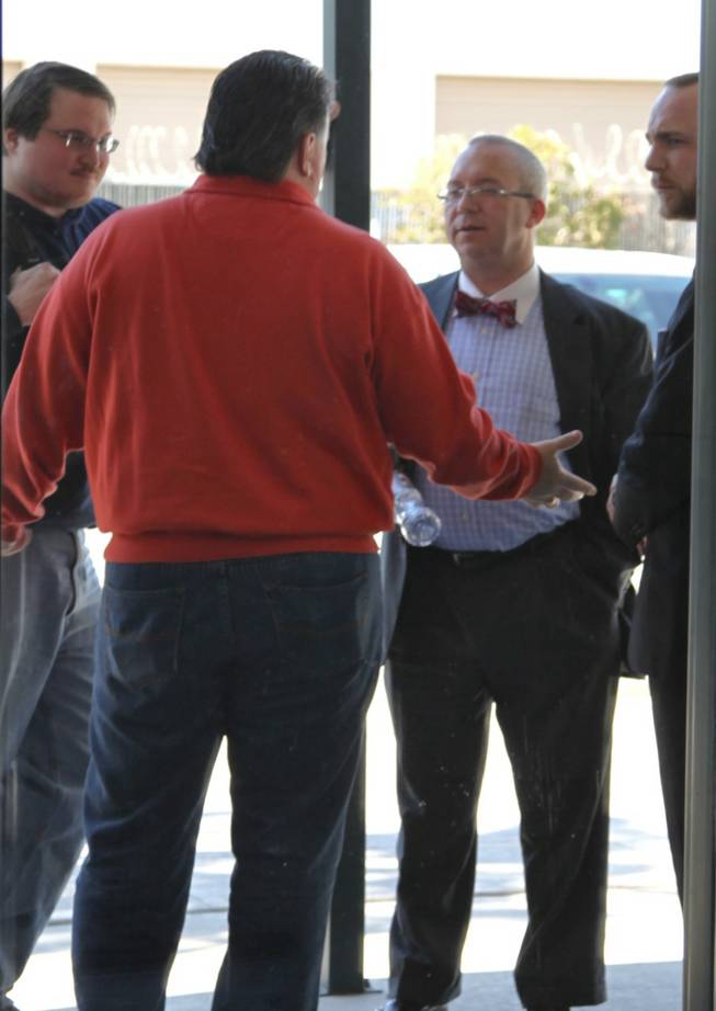 Michael McDonald, who is running to be chairman of the Nevada GOP, gestures and talks with lawyers and representatives for Ron Paul outside the Clark County GOP headquarters in Las Vegas, where party officials were having intense discussions with the presidential campaigns about the still-unreleased results of the Nevada caucuses Sunday morning.