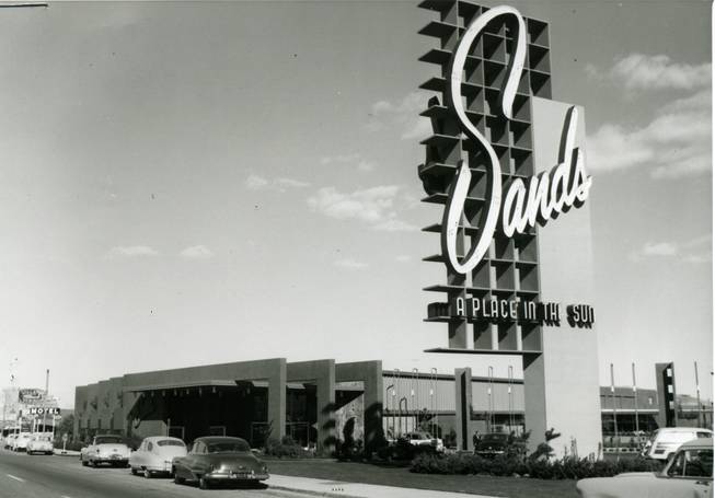 Cars line the Las Vegas Strip in front of the Sands casino in this 1950s photo.