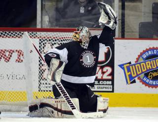 In a rare home start, Las Vegas goaltender Mitch O'Keefe rips a slapshot out of the air with is glove during the second period of play on Saturday night. 