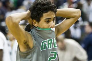 Green Valley High's Lorenzo Jarvis stands in disbelief at midcourt after the Gators' 70-68 loss to Northern Nevada's Hug High in the 4A state semifinals at Lawlor Events Center in Reno on Feb. 23, 2012.