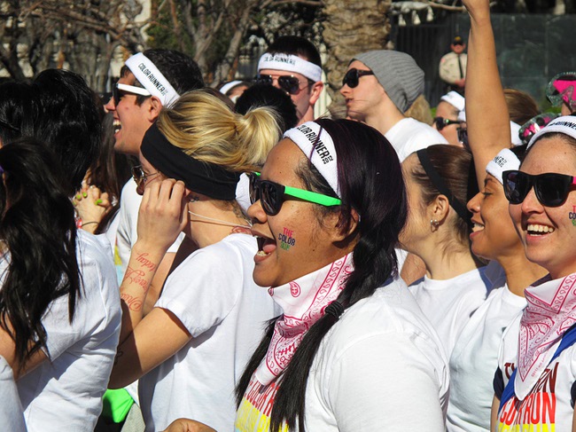 A woman cheers at the start of the first Color Run in downtown Las Vegas, Saturday, Feb. 25, 2012. About 5,000 participants ran a 5K event which benefits the Three Square charity.