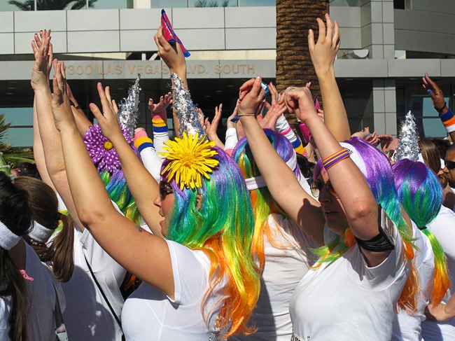 Women in colorful wigs cheer at the start of the first Color Run in downtown Las Vegas, Saturday, Feb. 25, 2012. About 5,000 participants ran a 5K event which benefits the Three Square charity.