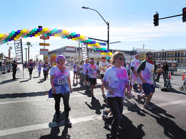 Runners cross the finish line during the first Color Run in downtown Las Vegas, Saturday, Feb. 25, 2012. About 5,000 participants ran a 5K event which benefits the Three Square charity.